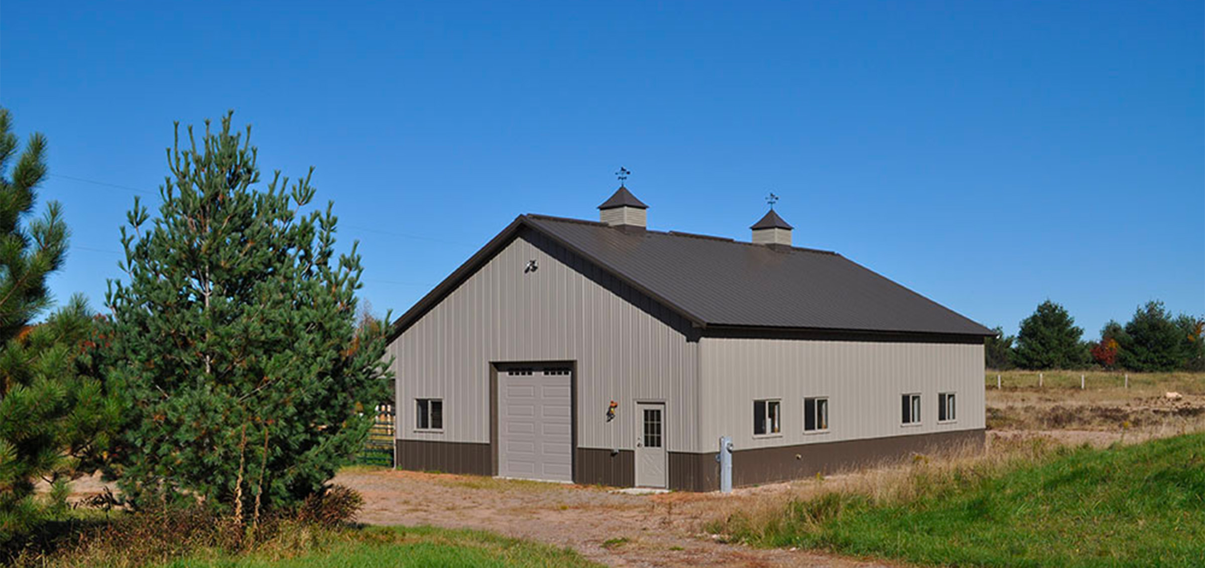 gray and brown post frame equine building